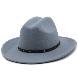 Detail view of the gray fedora cowboy hat with a studded black leather belt accessory