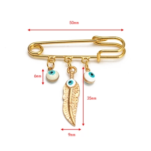 Detailed view of evil eye safety pin brooch with feather pendant and size measurements