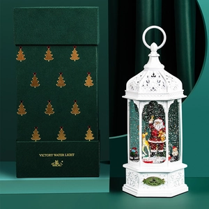 Vintage white snow globe lantern with Santa scene and festive green gift box packaging