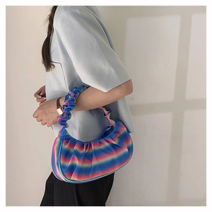 Detail of colorful rainbow pleated shoulder bag with satin finish and cloud-shaped texture