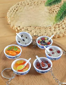 Miniature blue and white porcelain bowls with realistic food charms and metal keychains