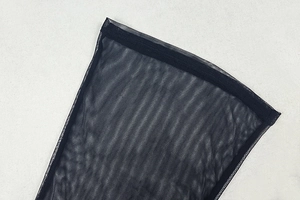 Detail of the sheer black mesh fabric and fine stitching on the athletic bodysuit