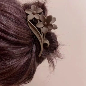 Elegant mocha brown flower hair claw clip with matte finish worn on back of head