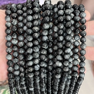 Macro shot of 8-10mm natural gray eagle eye stone beads with silky chatoyancy effect