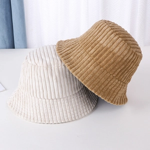 Texture detail of white and brown corduroy bucket hats for autumn and winter warmth