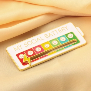 Detail view of the sliding yellow lightning bolt on My Social Battery enamel pin