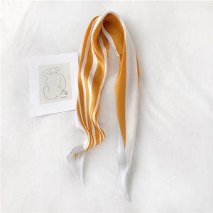 Detail of yellow and white striped silk scarf with smooth texture on white background