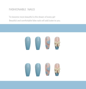 Detail of light blue bow and heart press-on nails in long coffin shape for women