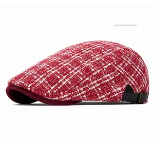 Detail of red tweed beret featuring metallic side buckle and premium fabric texture
