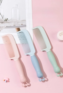 Detail of cute pastel plastic hair combs with cartoon bunny handles for girls.
