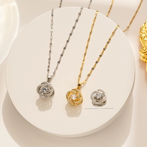 Detail of flower pendant showing 360-degree rotation in gold and silver steel