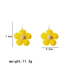 Detailed size view of yellow woven raffia flower earrings with 7.6cm height and 5.5cm width