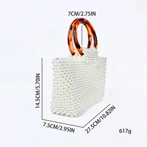 Detailed side view of handmade pearl beaded handbag with brown tortoiseshell ring handles