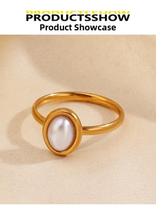 Macro detail of a vintage gold oval pearl ring on elegant beige silk fabric background