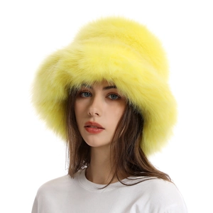 Detail of soft faux fur texture on the bright yellow thick plush winter bucket hat
