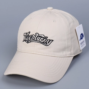 Detailed embroidery of Keeplucky letters on a beige twill cotton baseball cap