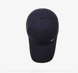 Top view of dark cotton baseball cap showing six-panel crown and silver metal letter detail