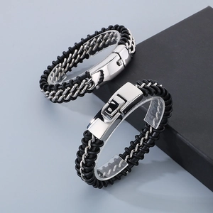 Close-up of punk style braided leather bracelets with polished stainless steel chain links