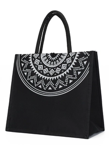 Large black jute tote bag with white geometric patterns and reinforced double handles