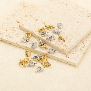 Detail of gold and silver knot pendants on stone for DIY necklace earring jewelry