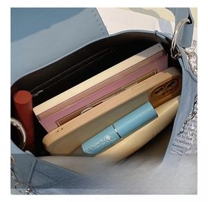Detailed interior of light blue crossbody bag showing large storage capacity for essentials