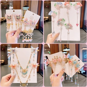 Detailed views of traditional Chinese hair clips with tassels, fans and floral beads