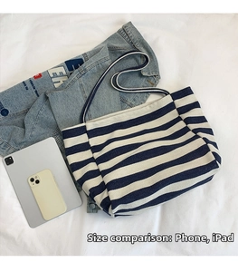 Detailed size comparison of the striped canvas tote bag with a tablet and smartphone