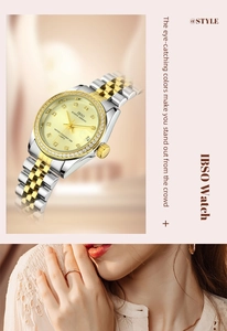 Macro detail of luxury quartz watch with diamond bezel and gold steel bracelet