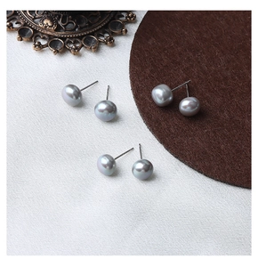 Detailed macro view of three pairs of grey freshwater pearl earrings with S925 silver pins