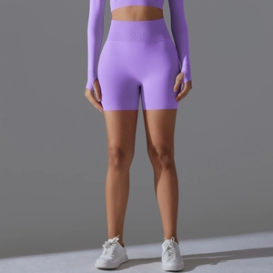Close-up of purple seamless yoga set with ribbed high waist and thumbhole sleeve details