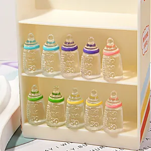 Miniature resin milk bottles with colorful caps and detailed measurement scales