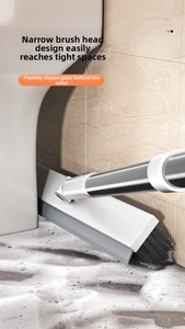 Detail showing the narrow floor brush head with stiff bristles cleaning tile grout and gaps