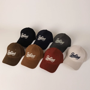 Detail of multi-color baseball caps stack with 3D Believe 1970 embroidery on cotton