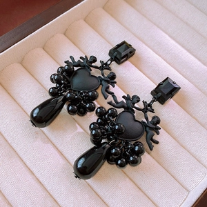 Detailed view of vintage black heart earrings with angel motifs and droplet pendants