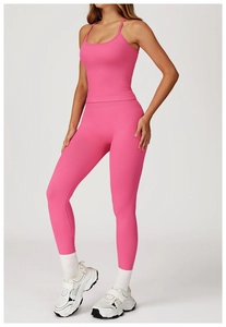 Close-up of bright pink ribbed knit yoga set featuring cross-back straps and high waist