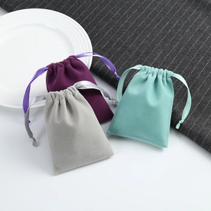 Macro detail of high-quality velvet drawstring jewelry pouches in purple and gray