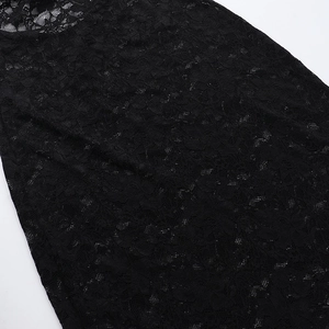 Close-up of intricate black floral lace pattern and hollow mesh texture on women dress