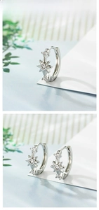 Detailed view of silver starburst hoop earrings with sparkling cubic zirconia stones