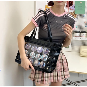 Detail of black faux leather ita bag with clear window and adjustable shoulder straps