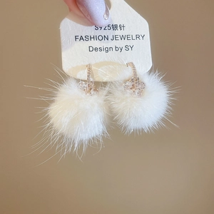 Detailed close-up of white plush flower earrings with sparkling crystals and S925 silver pins