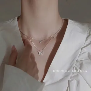 Elegant silver double-layer butterfly necklace with sparkling zircon pendants on model neck