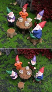 Detailed close-up of colorful resin garden gnomes set with miniature stumps and accessories