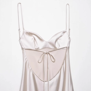 Champagne satin backless slip dress with lace-up detail and silky finish