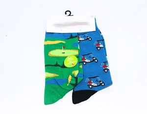 Detail of golf-themed mismatched cotton socks with green course and blue golf cart patterns