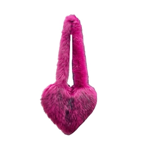 Faux fur heart-shaped crossbody bag in hot pink with fuzzy texture and shoulder strap