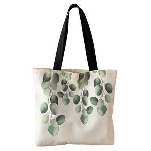 Minimalist canvas tote bag with green eucalyptus leaf print and black shoulder strap
