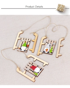 Detailed view of DIY wooden Christmas gnome sled pendants with Nordic painted patterns