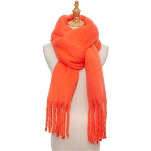 Close-up of bright orange mohair knit scarf with long tassels on a white background