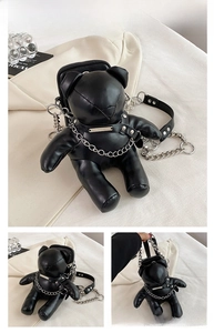 Detail of black bear-shaped PU leather bag featuring silver chain strap and metal rivet accents