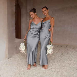 Detail of silver silk slip dress with deep V-neckline and elegant draping fabric